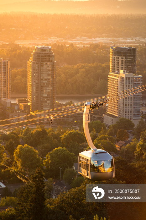 Cable car in Portland, Oregon, USA with wonderful view on sunrise with mt. Hood and aerial tram going to OHSU