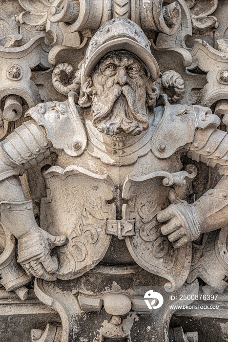 Very old statute of scary and heavy armed gatekeeper, medieval warrior with weapon in historical downtown of Dresden, Germany