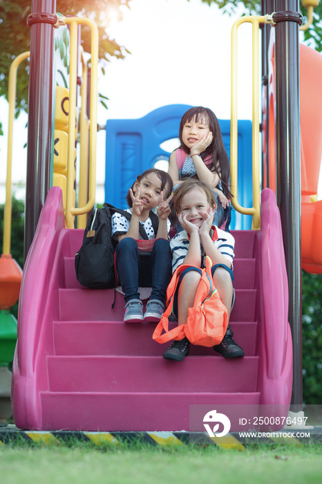 group of international kids preschool enjoy playing in schoolyard together