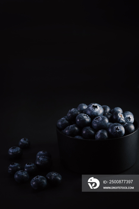 blueberries on black background