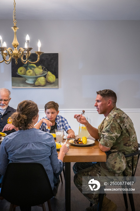Air Force service member fixes and eats dinner with family.