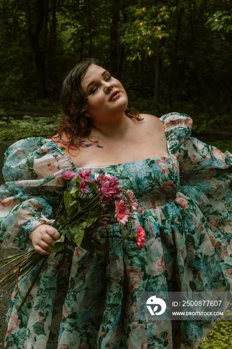 portrait of a plus size woman holding flowers