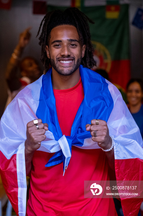 Man dressed in national flag for world cup competition posing for portrait