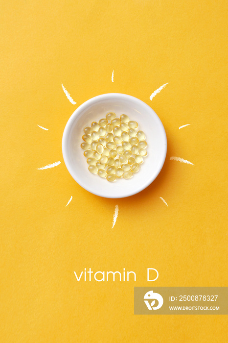 Tablets on a plate inside a picture of the sun and the inscription: vitamin D