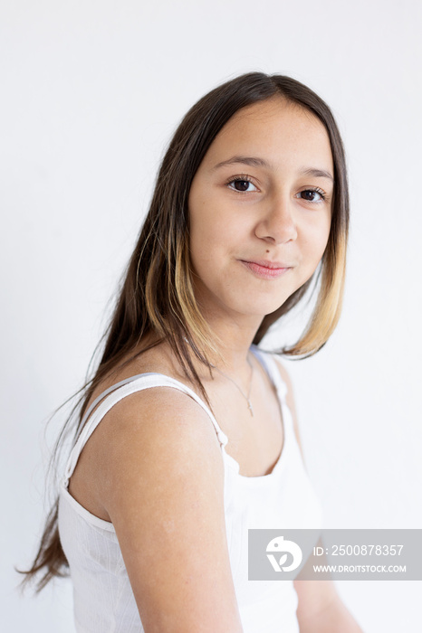 Portrait of smiling girl on white background