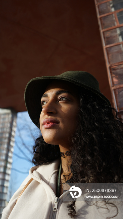 Close-up of pensive woman in hat outdoors