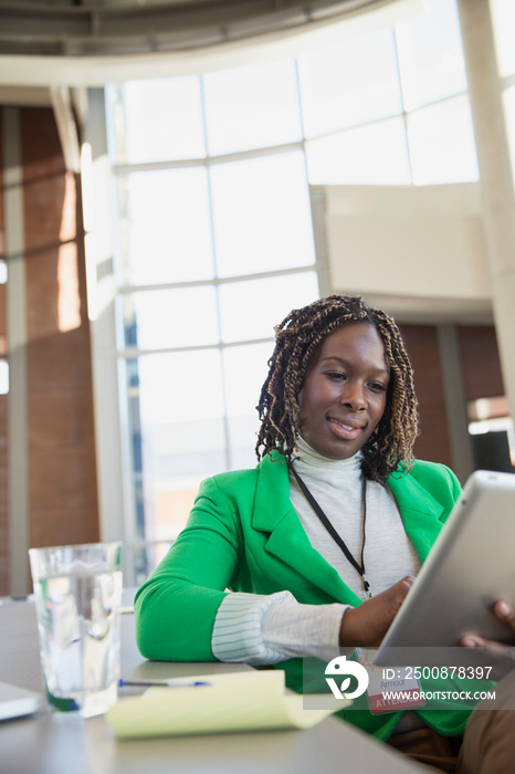 Woman using tablet computer in modern office.