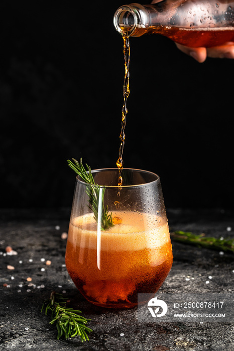 Red low alcohol drink, chilled colorful beverages on rustic black background. summer party. Alcoholic drink concept. Freeze motion, drops in liquid splash