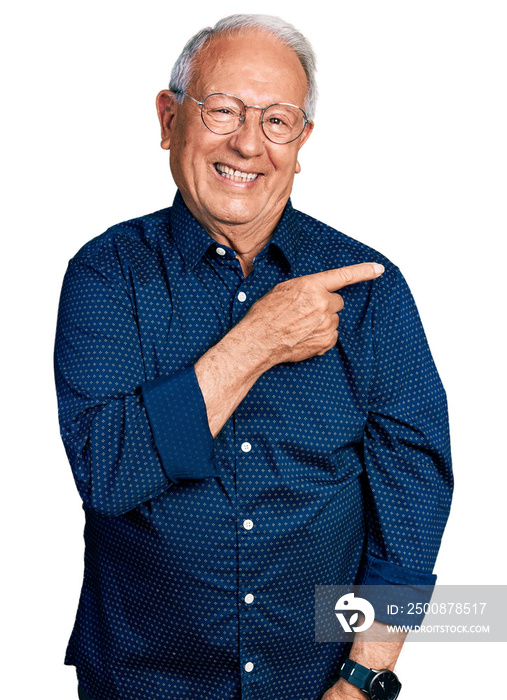 Senior man with grey hair wearing casual shirt and glasses cheerful with a smile of face pointing with hand and finger up to the side with happy and natural expression on face