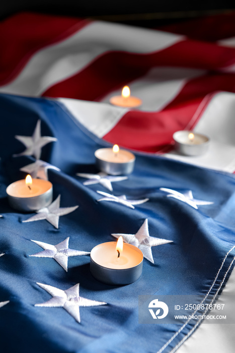 Burning candles on USA flag. National Day of Prayer and Remembrance for the Victims of the Terrorist Attacks