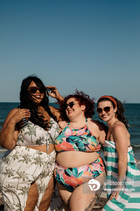 3 friends stand together smiling