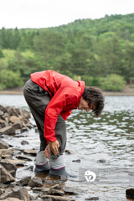 Young man wading in lake