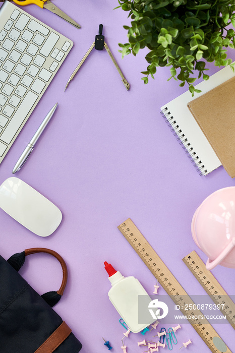 Top view flatlay composition of girly lifestyle items on pastel purple background, computer keyboard office supplies on desk in office, copy space