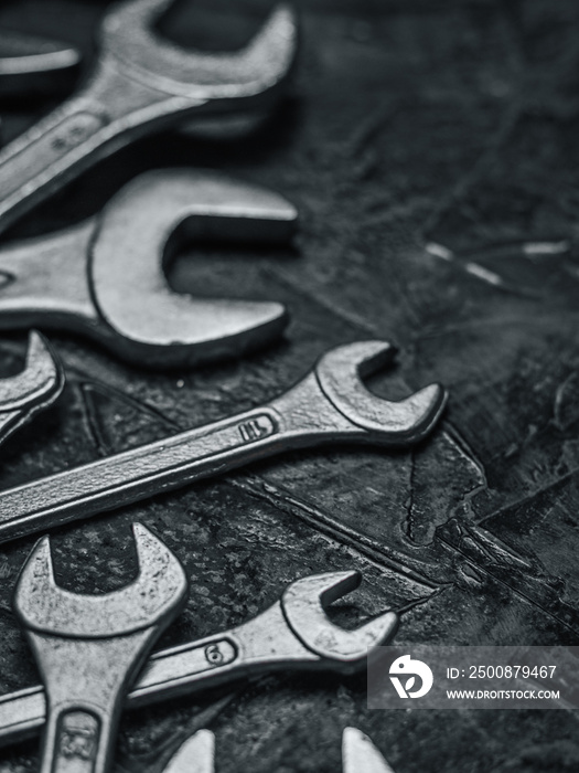 Wrenches, tools on grey stone table. Worker tools and equipments close-up.