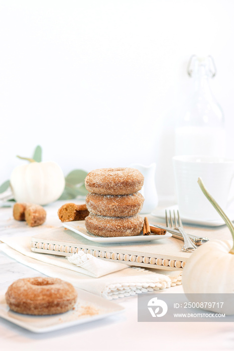 stack of apple cider donuts on white background