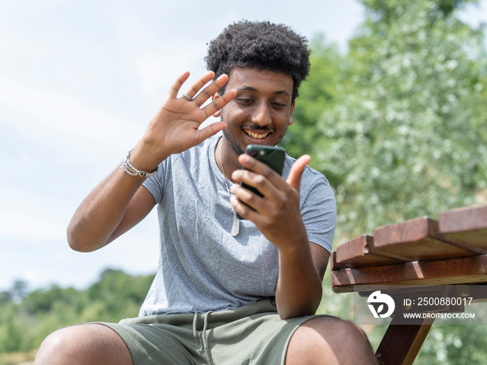 Smiling man during video call on sunny day