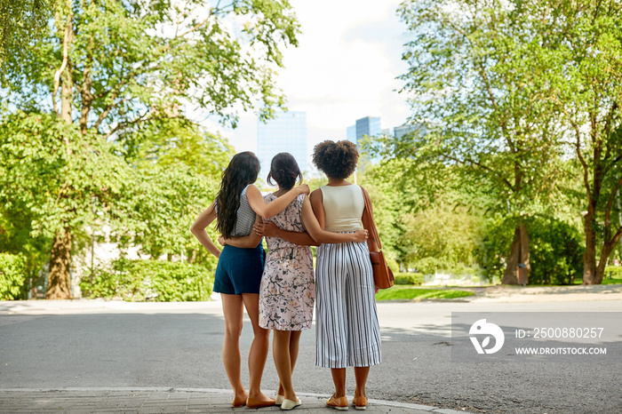 female friendship, people and leisure - young women or friends hugging at summer park