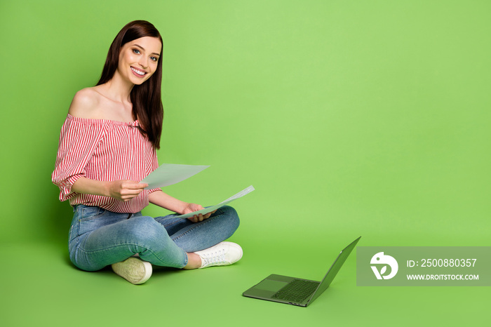 Full body size photo of cute pretty student girl cross legs work freelance hr casting managing wear denim striped white red shirt uncovered shoulders bright green color background