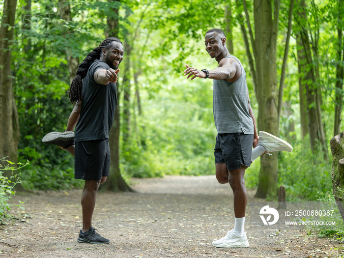 Two men stretching in forest