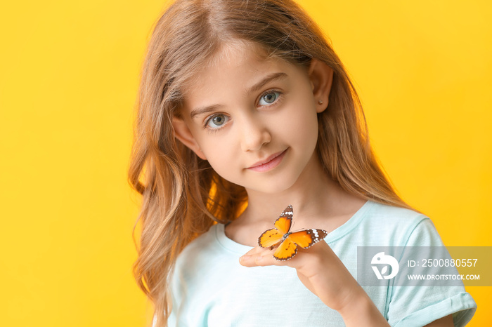 Cute little girl with butterfly on color background