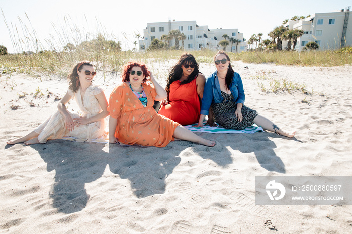 4 friends hang out on the sand