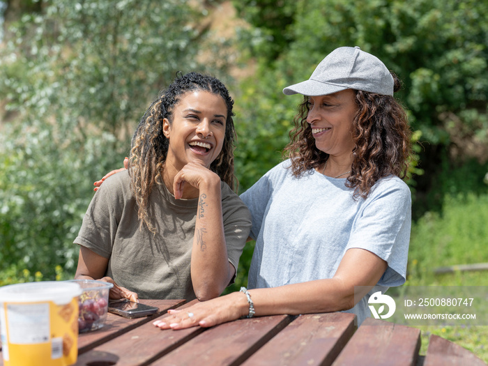 Friends laughing during picnic