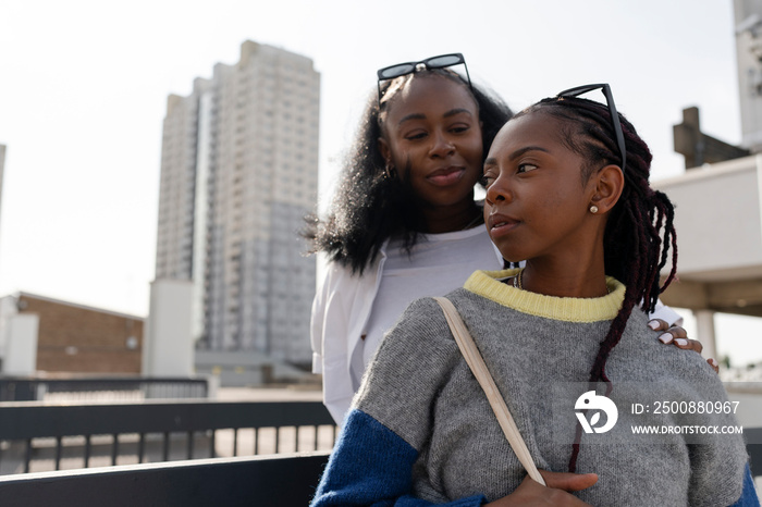 Young stylish female couple in city