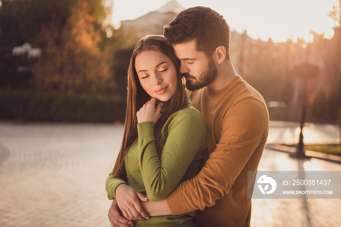 Passionate couple guy embrace cuddle his girlfriend in fall october nature town park wear yellow green turtleneck sweater