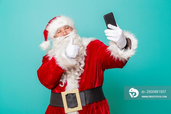 Santa Claus taking a selfie using smartphone