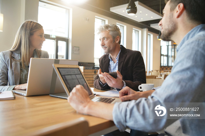 Mixed sales team working through presentation before meeting