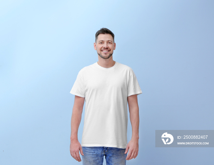 Young man in t-shirt on color background. Mockup for design