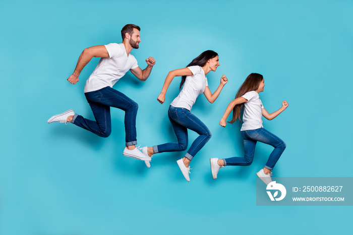 Full length body size photo of running sporty family being healthy and beautiful while isolated with blue background