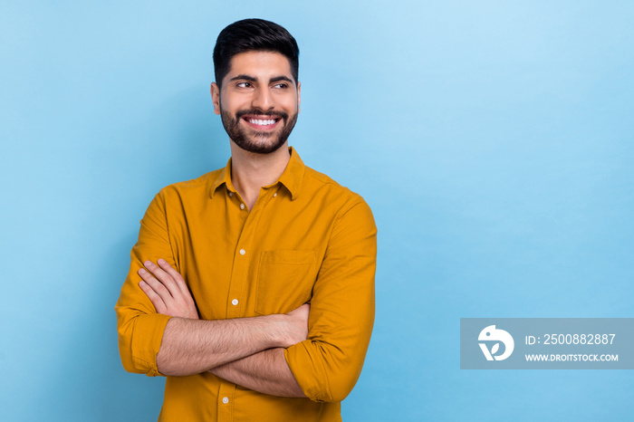 Photo of good brunet young guy crossed hands look promo wear brown shirt isolated on blue color background