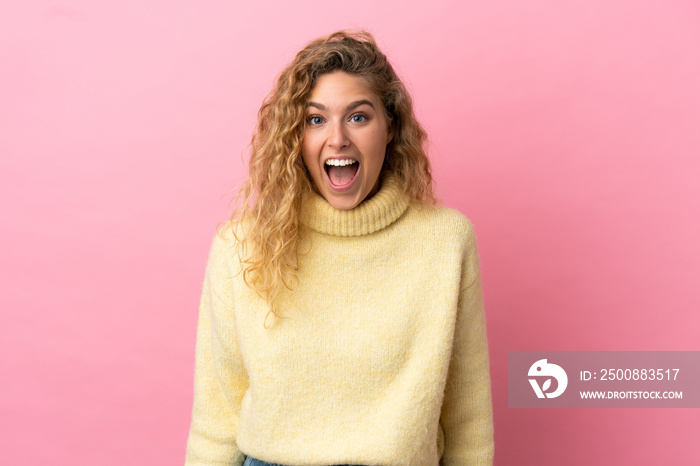 Young blonde woman isolated on pink background with surprise facial expression