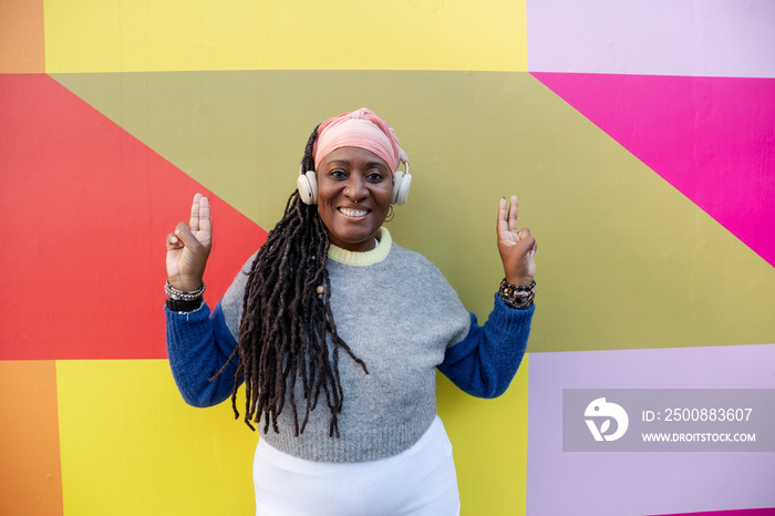 Portrait of beautiful woman with dreadlocks on colorful background