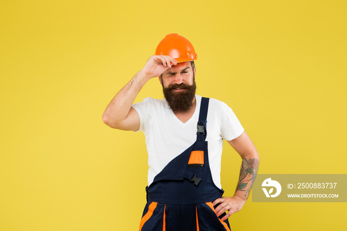 Bearded guy worker on yellow background. Home Design and Renovation Trends. Engineer builder uniform. Man builder hard hat. Creativity and practice. Improvement and renovation. Brutal man builder