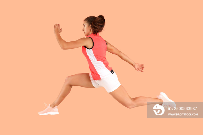 Running sporty woman on color background