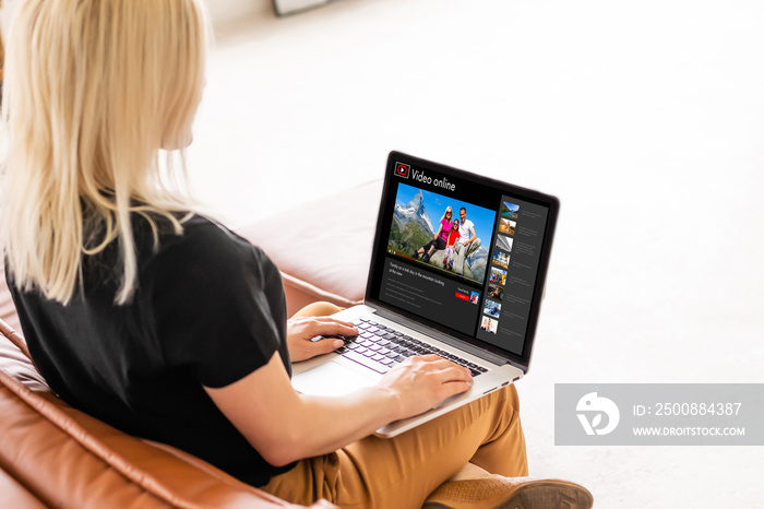 Happy woman planning vacations on line searching information in a laptop in a resort or hotel.