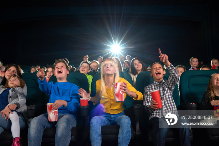 Low angle shot of cinema hall full of children enjoying a movie together copyspace background people kids youth lifestyle positivity expressive emotional entertaining fun activity concept.