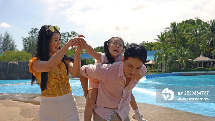 A happy family of mother, father and children, daughter, having fun on vacation