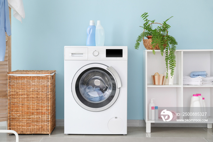 Interior of home laundry room with modern washing machine