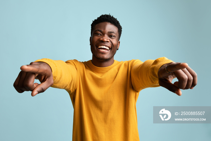 Charismatic african american man posing on blue, smiling and gesturing