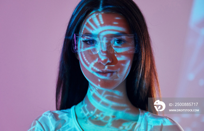 Abstract picture. Beautiful young woman is in projector neon lights in the studio