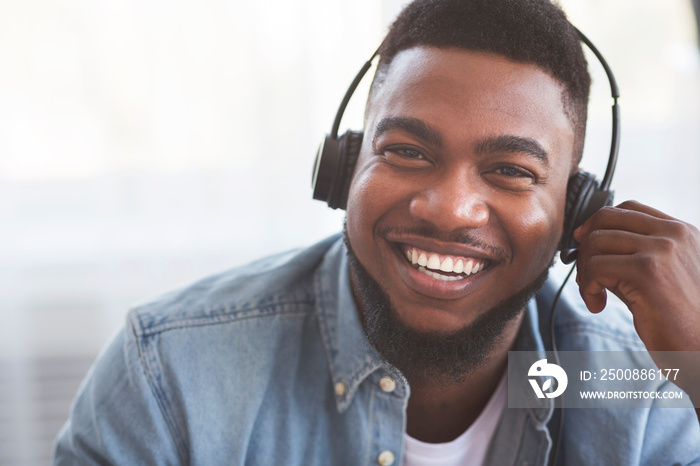 Portrait of smiling black call center operator in headset