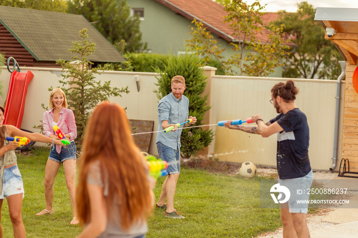 Friends playing with squirt guns