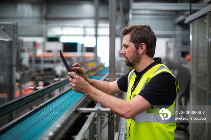 Factory worker using a digital tablet in factory