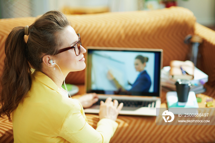 relaxed stylish woman with white headphones study online