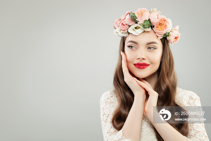 Happy beautiful woman on gray banner background. Pretty girl with clear skin, long shiny hair and flowers