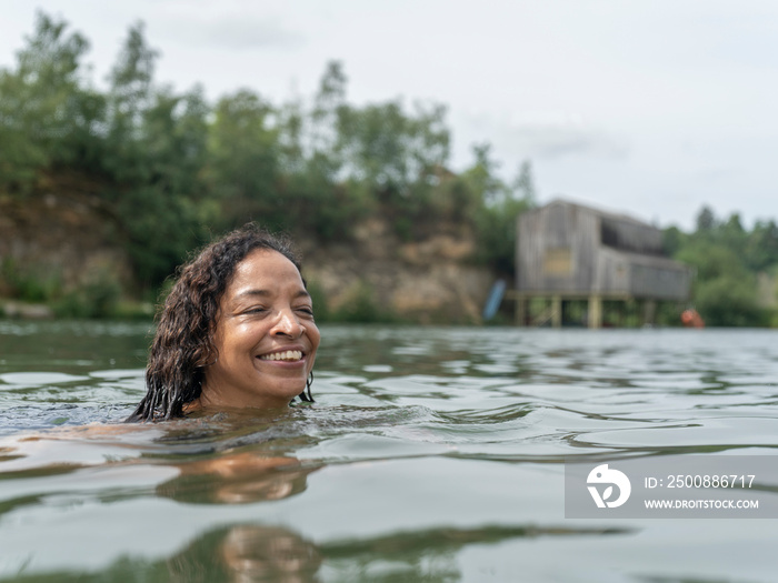 Smiling woman swimming in lake