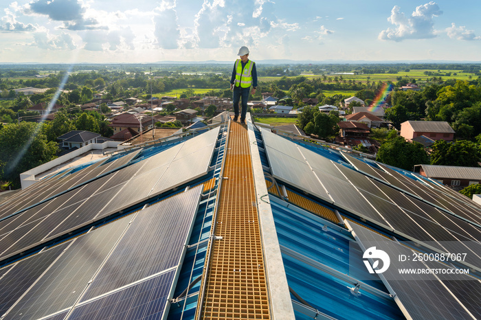 Asian engineer checking equipment in solar power plant on roof. clean energy